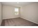 Spacious bedroom with neutral carpeting and window at 2049 Stillview Pass, Zephyrhills, FL 33541