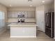 Modern kitchen with gray cabinets, quartz countertops, and stainless steel appliances at 2049 Stillview Pass, Zephyrhills, FL 33541