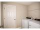Laundry room with washer, dryer, and shelving at 2049 Stillview Pass, Zephyrhills, FL 33541