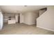 Spacious living room with light wood-look flooring and kitchen view at 2049 Stillview Pass, Zephyrhills, FL 33541