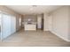 Spacious living room with light wood-look flooring and kitchen view at 2049 Stillview Pass, Zephyrhills, FL 33541