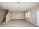 Spacious living room with light wood-look flooring and sliding glass door at 2049 Stillview Pass, Zephyrhills, FL 33541