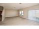 Spacious living room with light wood-look flooring and sliding glass door at 2049 Stillview Pass, Zephyrhills, FL 33541