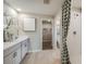 Bathroom with double vanity, walk-in shower, and separate toilet area at 2103 Stillview Pass, Zephyrhills, FL 33541