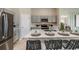 Modern kitchen with island seating, gray cabinets, and quartz countertops at 2103 Stillview Pass, Zephyrhills, FL 33541