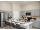 Modern kitchen with gray cabinets, stainless steel appliances, and an island at 2103 Stillview Pass, Zephyrhills, FL 33541