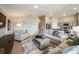 Open living space with kitchen view, neutral decor, and hardwood floors at 2103 Stillview Pass, Zephyrhills, FL 33541