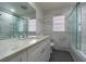 Modern bathroom with white cabinets and marble tile at 220 74Th N Ave, St Petersburg, FL 33702