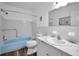 Bathroom with marble vanity and blue bathtub at 2221 Swedish Dr # 11, Clearwater, FL 33763