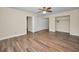 Bedroom with wood-look floors, ceiling fan, and closet space at 2221 Swedish Dr # 11, Clearwater, FL 33763