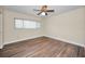 Bedroom with wood-look floors, ceiling fan, and a window at 2221 Swedish Dr # 11, Clearwater, FL 33763