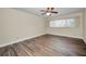 Bedroom with wood-look floors, ceiling fan, and a window at 2221 Swedish Dr # 11, Clearwater, FL 33763