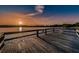 Serene lake view from wooden dock, with chair under vibrant sunset at 2221 Swedish Dr # 11, Clearwater, FL 33763