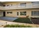 Attractive two-story building with a well-manicured lawn and shrubbery in front of the entrance of unit 11 at 2221 Swedish Dr # 11, Clearwater, FL 33763