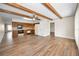 Open floor plan with kitchen featuring wood cabinets, white appliances, and wood-look floors throughout at 2221 Swedish Dr # 11, Clearwater, FL 33763