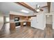 Open kitchen with wood cabinets, white appliances, and wood-look floors plus space for a kitchen table at 2221 Swedish Dr # 11, Clearwater, FL 33763