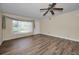 Bright living room with gorgeous wood-look flooring, a ceiling fan, and lots of natural light at 2221 Swedish Dr # 11, Clearwater, FL 33763