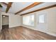 Bright living room with wood-look flooring, a ceiling fan, and lots of natural light from the windows at 2221 Swedish Dr # 11, Clearwater, FL 33763