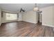 Cozy living room features wood-look floors, ceiling fan, and a large window for lots of natural light at 2221 Swedish Dr # 11, Clearwater, FL 33763