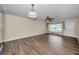 Open living room with wood-look floors, a ceiling fan, and a front door at 2221 Swedish Dr # 11, Clearwater, FL 33763