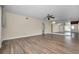 Spacious living room with beautiful wood-look floors, ceiling fan and a mirrored wall at 2221 Swedish Dr # 11, Clearwater, FL 33763