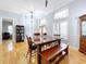 Bright dining area featuring a farmhouse table and bench at 2898 Grey Oaks Blvd, Tarpon Springs, FL 34688