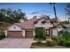 Beautiful two-story home with a three-car garage and manicured landscaping at 2898 Grey Oaks Blvd, Tarpon Springs, FL 34688