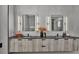 Double vanity bathroom with dark countertop and modern lighting at 3010 W Trilby Ave, Tampa, FL 33611