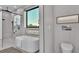 Bathroom with soaking tub, walk-in shower, and modern fixtures at 3010 W Trilby Ave, Tampa, FL 33611