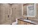 Modern bathroom with glass shower, floating vanity, and dark countertops at 3010 W Trilby Ave, Tampa, FL 33611