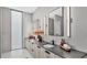 Double vanity bathroom with dark countertops and sleek lighting at 3010 W Trilby Ave, Tampa, FL 33611