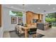 Modern dining area with a sleek table and chairs, and an open kitchen at 3010 W Trilby Ave, Tampa, FL 33611