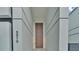 Elegant entryway with a tall wooden door and modern lighting at 3010 W Trilby Ave, Tampa, FL 33611