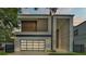 Modern home with a clean design, featuring a glass garage door and a paved driveway at 3010 W Trilby Ave, Tampa, FL 33611
