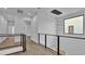 Modern hallway with wood floors and sleek metal railing at 3010 W Trilby Ave, Tampa, FL 33611
