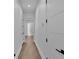 Bright hallway with light wood floors and white walls at 3010 W Trilby Ave, Tampa, FL 33611