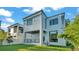 Modern two-story home with a backyard and landscaped lawn at 3010 W Trilby Ave, Tampa, FL 33611