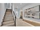 Modern staircase with a metal railing and dark wood steps at 3010 W Trilby Ave, Tampa, FL 33611