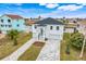 Modern two-story home, gray pavers, and a canal view at 3431 Palometa Dr, Hernando Beach, FL 34607