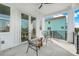 Relaxing balcony with stylish chairs and small table, offering views of the neighborhood at 3431 Palometa Dr, Hernando Beach, FL 34607