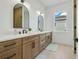 Modern bathroom with double sinks, light wood cabinets, and a large mirror at 3431 Palometa Dr, Hernando Beach, FL 34607