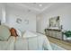 Guest bedroom with a queen bed and light and airy decor at 3431 Palometa Dr, Hernando Beach, FL 34607