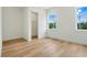 Bright bedroom with light wood floors and large windows at 3431 Palometa Dr, Hernando Beach, FL 34607
