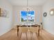 Elegant dining room features a wooden table, woven chairs, and a stunning chandelier at 3431 Palometa Dr, Hernando Beach, FL 34607