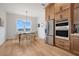 Bright dining area features a wooden table with woven chairs and a view from a large window at 3431 Palometa Dr, Hernando Beach, FL 34607