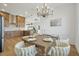 Bright dining room features a wood table with seating for six and a modern chandelier at 3431 Palometa Dr, Hernando Beach, FL 34607