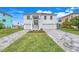 White two-story house with gray paver driveway and landscaping at 3431 Palometa Dr, Hernando Beach, FL 34607