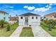 Two-story home with gray paver driveway and modern design at 3431 Palometa Dr, Hernando Beach, FL 34607