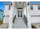 Modern house entrance with double doors and steps at 3431 Palometa Dr, Hernando Beach, FL 34607