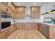 Modern kitchen with stainless steel appliances and light wood cabinets at 3431 Palometa Dr, Hernando Beach, FL 34607